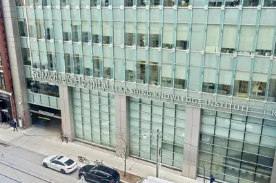 an office building with a sign on the side of it at RivetStays - The Pantages Suite in Toronto