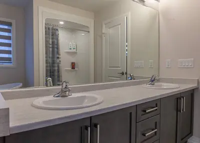a bathroom with two sinks and a large mirror at 4Bed25 BathBrand newNiagara FallsSleeps12 in Thorold