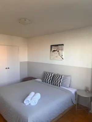 a bedroom with a bed with two towels on it at The Charming Downtown Stop in Toronto