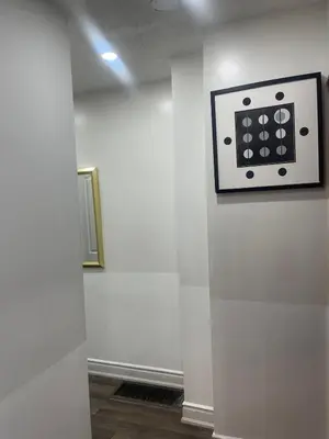 a white wall with a clock on a wall at Three Bedroom Spacious Bangalow with Free Parking, closer to commercial area and highways in Mississauga