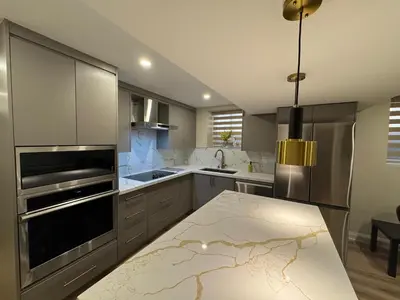 a kitchen with stainless steel appliances and a table at Luxury 2-Bedroom Designer Suite Richmond Hill Lake Wilcox in Richmond Hill