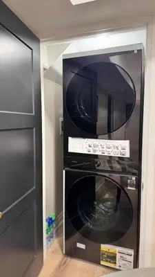 a black microwave oven sitting in a kitchen at Luxury 2-Bedroom Designer Suite Richmond Hill Lake Wilcox in Richmond Hill