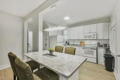 a kitchen with a table with chairs and a counter top at Chic 2 BR Urban Retreat Near Beach Free Parking in Oshawa