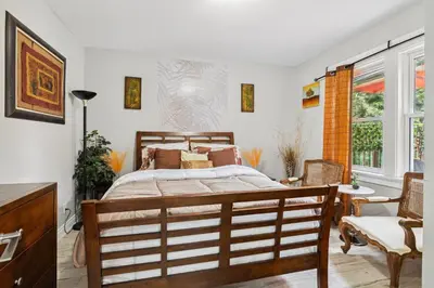 a bedroom with a bed and a table and chairs at Ora's Place BNB in Niagara Falls
