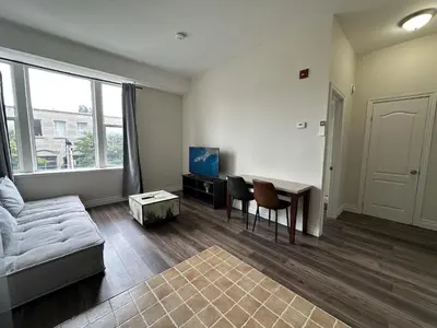 a living room with a couch and a table at Furnished Simcoe Lofts in Oshawa
