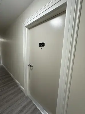 a door with a sign on it in a room at Furnished Simcoe Lofts in Oshawa