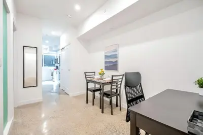 a kitchen and dining room with a table and chairs at Chic 2BR Basement Suite 2BR Toronto Getaway near Downtown - The Roland in Toronto