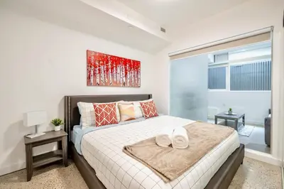 a bedroom with a bed with two hats on it at Inviting 2BR Basement Suite in Downtown Toronto - The Roland in Toronto