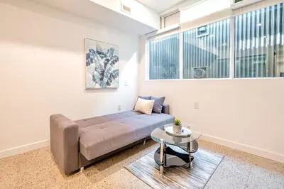 a living room with a couch and a glass table at Inviting 2BR Basement Suite in Downtown Toronto - The Roland in Toronto
