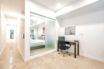 a home office with a desk and a bedroom at Inviting 2BR Basement Suite in Downtown Toronto - The Roland in Toronto