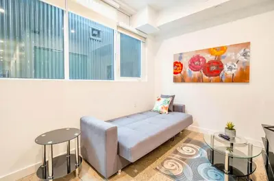 a living room with a couch and two tables at Peaceful 2BR Basement Suite Near Downtown Toronto - The Roland in Toronto