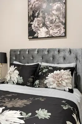 a bed with black and white pillows on it at Luxury Lakeview Downtown Condo, CN Tower, Rogers Center, Scotia Arena, Lake View with Free Parking in Toronto