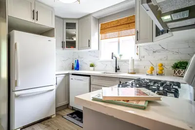 a kitchen with white appliances and a white refrigerator at 2 Bedroom house in East-York in Toronto