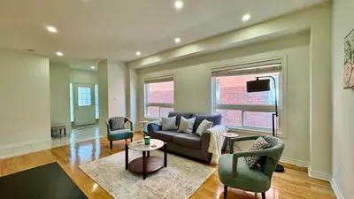 a living room with a couch and two chairs at Spacious 4BD Oasis with Sauna in Mississauga