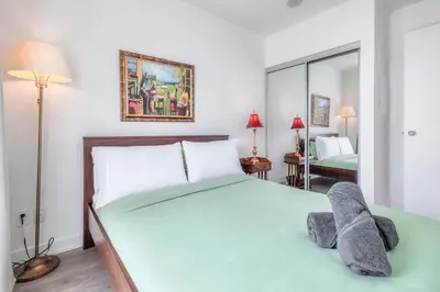 a bedroom with a bed with a stuffed animal on it at Downtown 1BR City Stay with Balcony and Fast Wi-Fi in Toronto