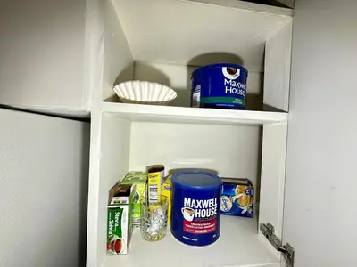 a white cabinet with some food items in it at Mountain View House - Sleeps 14 in St. Catharines