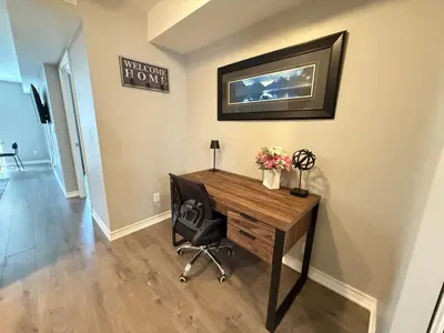 a home office with a desk and a chair at Large Downtown 2Br condo with Parking steps to Eaton Centre, UofT and SickKids in Toronto