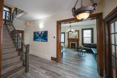 a living room with a staircase and a couch at Comic House with Climbing Wall & Themes in Chesley