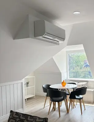a dining room with a table and chairs and a window at The Dove Loft Near DT & Hospital in Peterborough