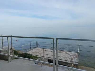 a view of the ocean with a metal railing at 5 o clock somewhere in Hamilton