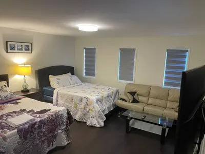 a hotel room with a bed and a couch and a bed and a couch at Largest ensuite bedroom in a guest house in Whitby