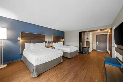 a hotel room with two beds and a blue wall at Tru By Hilton Oshawa in Oshawa
