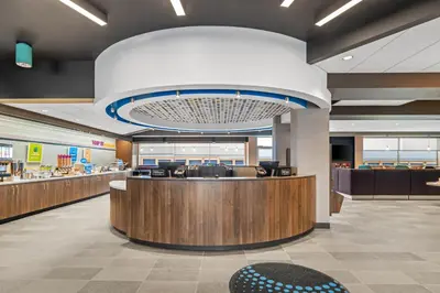 a lobby of a store with a large chandelier at Tru By Hilton Oshawa in Oshawa