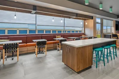 a restaurant with a bar and stools at Tru By Hilton Oshawa in Oshawa