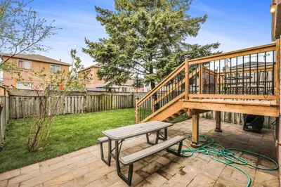 a wooden deck with a bench on a patio at 3BR Pickering Retreat with BBQ and Patio Delight in Pickering