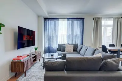 a living room with a couch and a tv at Stylish 3BDR in Pickering Heart Free Parking in Pickering