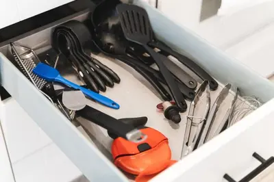 a drawer filled with cooking utensils and a pair of scissors at Waterfront Bliss Firepit and BBQ in Hanover