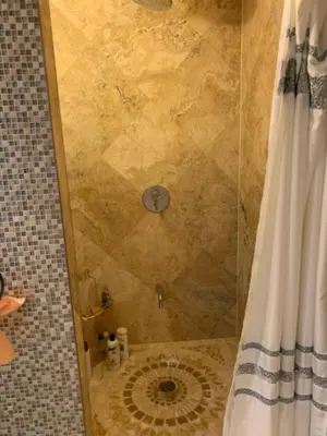 a shower with a shower curtain in a bathroom at Basement apartment in Vaughan