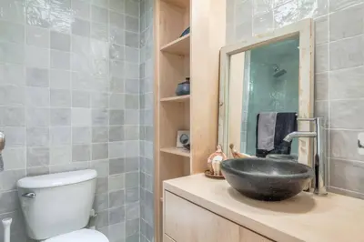 a bathroom with a sink and a toilet at Cozy 2BR Home with Workspaces, Fireplace and Parking in Toronto
