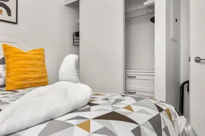 a bedroom with a bed and a yellow pillow at Downtown Urban Oasis I Entertainment District in Toronto