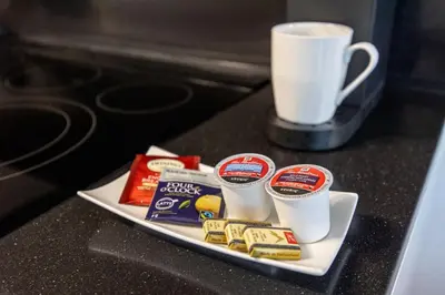 a plate of food and a cup of coffee on a counter at Downtown Urban Oasis I Entertainment District in Toronto
