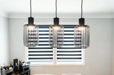 a kitchen with three lights hanging over a window at Outdoor Sauna Hot Tub Playroom Port Dallhousie in St. Catharines