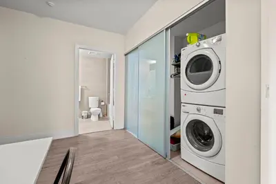a laundry room with a washer and dryer at Luxury 2 Bedroom CN Tower View in Toronto