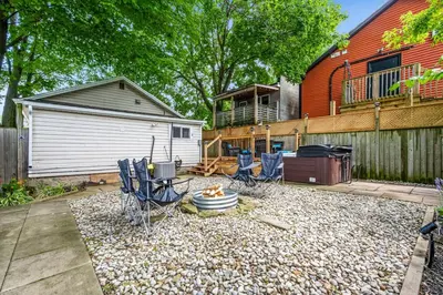 a backyard with chairs and a fire pit and a house at Crystal Tides Retreat in Fort Erie