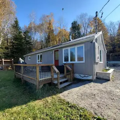 a tiny house sitting on top of a yard at Our Happy Place in Wilberforce