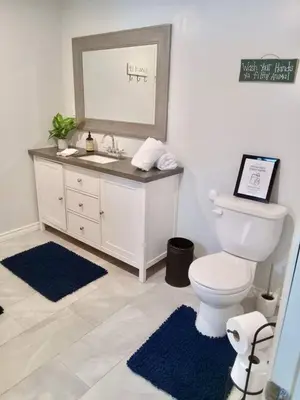 a bathroom with a toilet and a sink and a mirror at Our Happy Place in Wilberforce