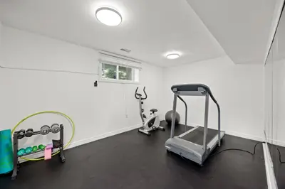 a gym with two exercise bikes and a mirror at The Wilcox Villa in Mississauga