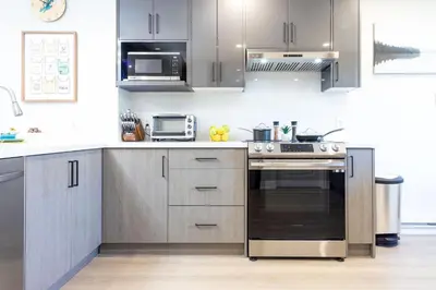a kitchen with stainless steel cabinets and a stove at Stylish 2bed, 2bth Apt Malls & 25 Mins to Toronto in Mississauga