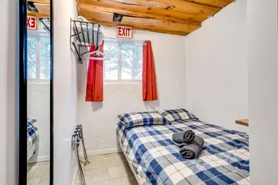 a bedroom with a bed and a window at Happy Daze Big Space Near Village Hot Tub 38L-194 in Blue Mountains