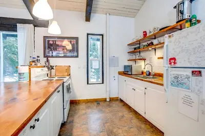 a kitchen with white cabinets and a wooden counter top at Happy Daze Big Space Near Village Hot Tub 38L-194 in Blue Mountains