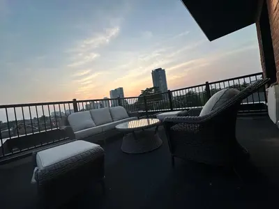 a balcony with a couch and chairs and a table at Mins from Toronto Downtown UFT Exhibition Place in Toronto