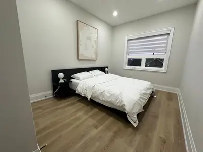 a bedroom with a large bed and a window at Mins from Toronto Downtown UFT Exhibition Place in Toronto