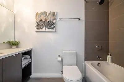 a bathroom with a toilet and a sink and a bath tub at Gorgeous 1 Bedroom Apt with Balcony in Yorkville in Toronto