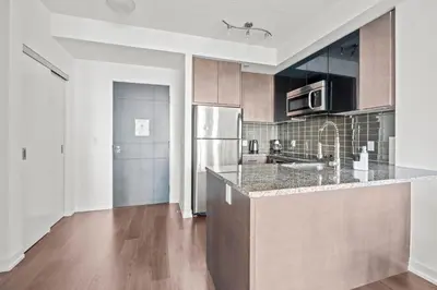 a kitchen with a counter and a refrigerator at Cozy 1 Bedroom Dunfield Ave in Toronto