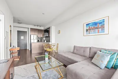 a living room with a couch and a table at Cozy 1 Bedroom Dunfield Ave in Toronto
