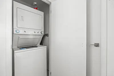 a washer and dryer with a microwave above it at Cozy 1 Bedroom Dunfield Ave in Toronto